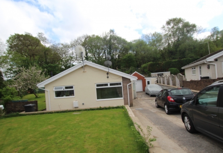 3 Bedroom bungalow with large wrap around garden and garage with drive to accommodate 3 cars.